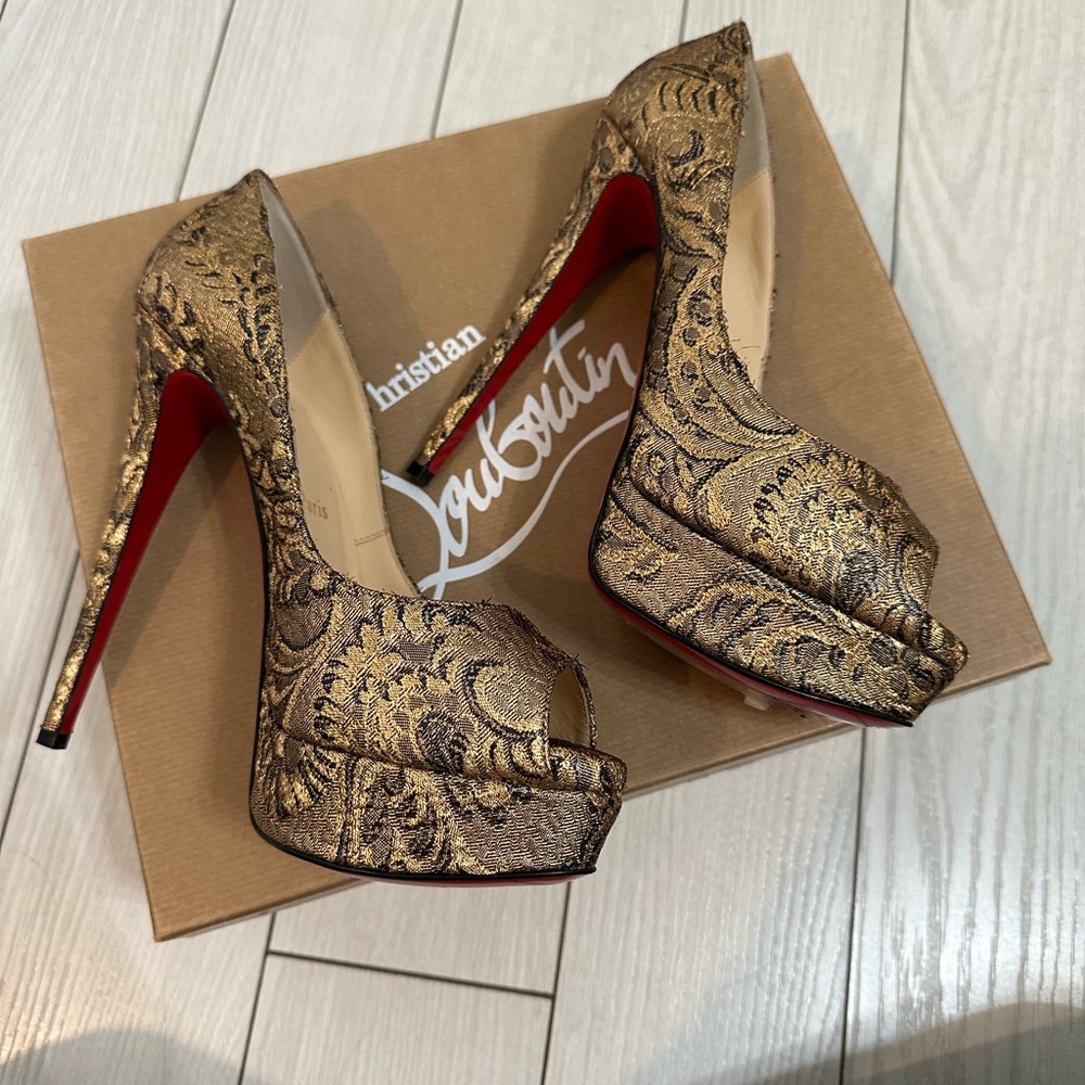 Christian Louboutin gold pumps